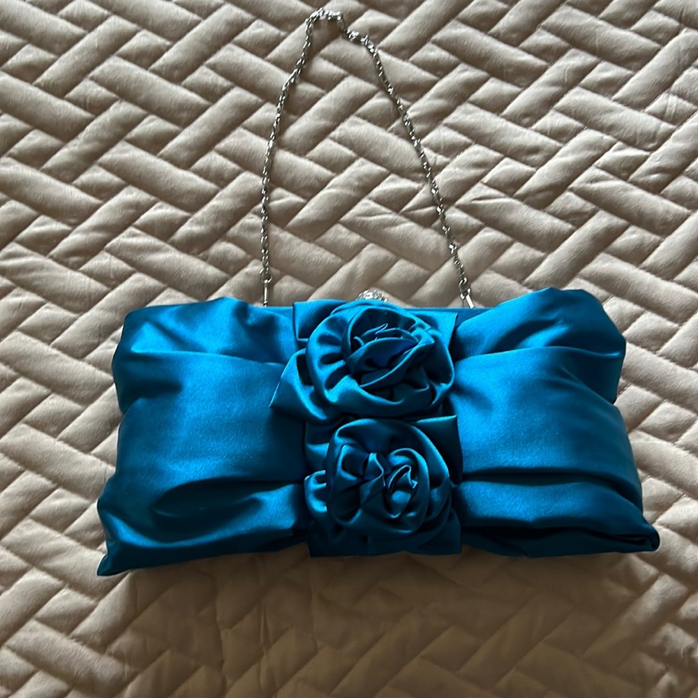 Beautiful peacock blue evening clutch. It’s 10 inches and satin.